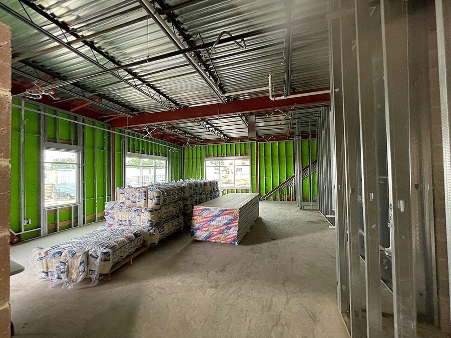 Commercial interior jobsite in Texas featuring metal stud framing, industrial insulation, and open plenum ceiling construction by Five Oak Construction