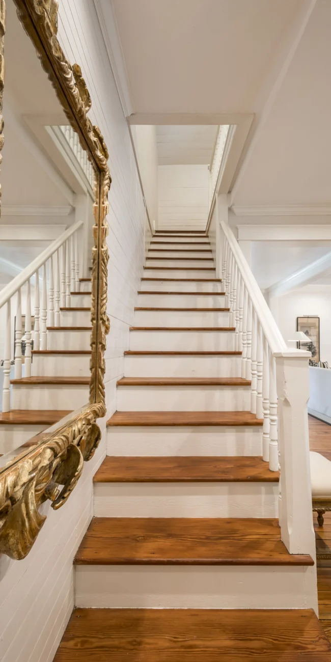 Luxury residential interior featuring a custom-built staircase and high-end finish carpentry by Texas home renovation contractors